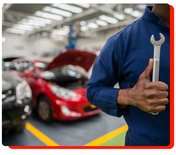 "Auto technician holding wrench in a vehicle repair shop in Etobicoke"