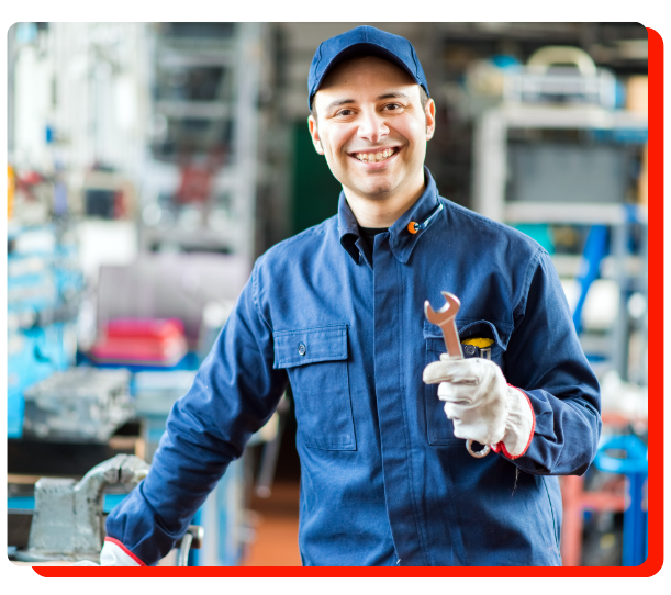 "Smiling auto technician holding wrench at Venus Auto Performance in Etobicoke"