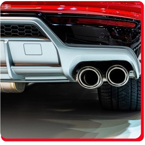 Close-up of a vehicle’s dual chrome exhaust system ready for inspection or repair.