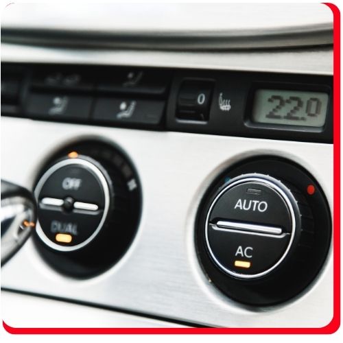 Close-up of car dashboard showing automatic air conditioning controls.